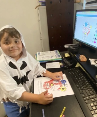 Diluu student showing his Día de los Muertos activity